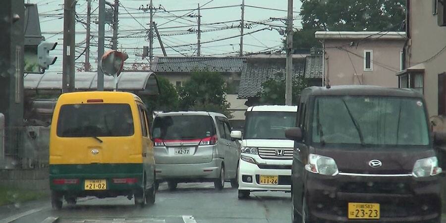 黄色の車を挟んでグレーの車を追う